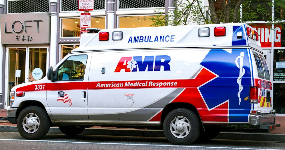 Paramedics loading a patient into an ambulance during an emergency response