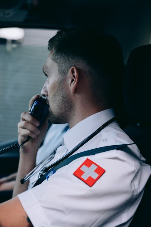 Paramedic using a radio inside an ambulance during emergency response